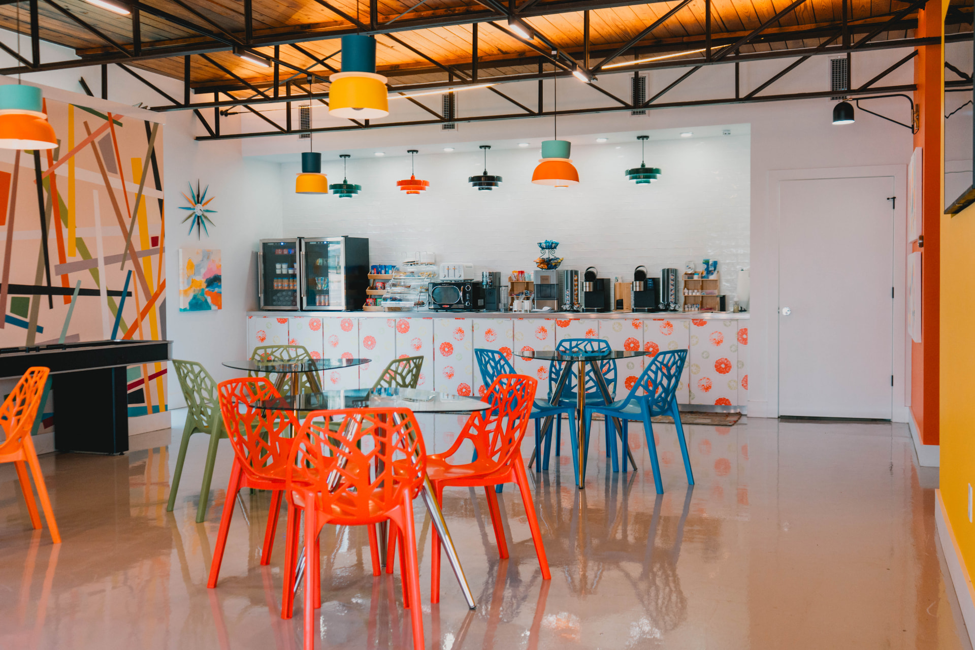 Coffee and snack bar with retro pendant lamps and bright seating