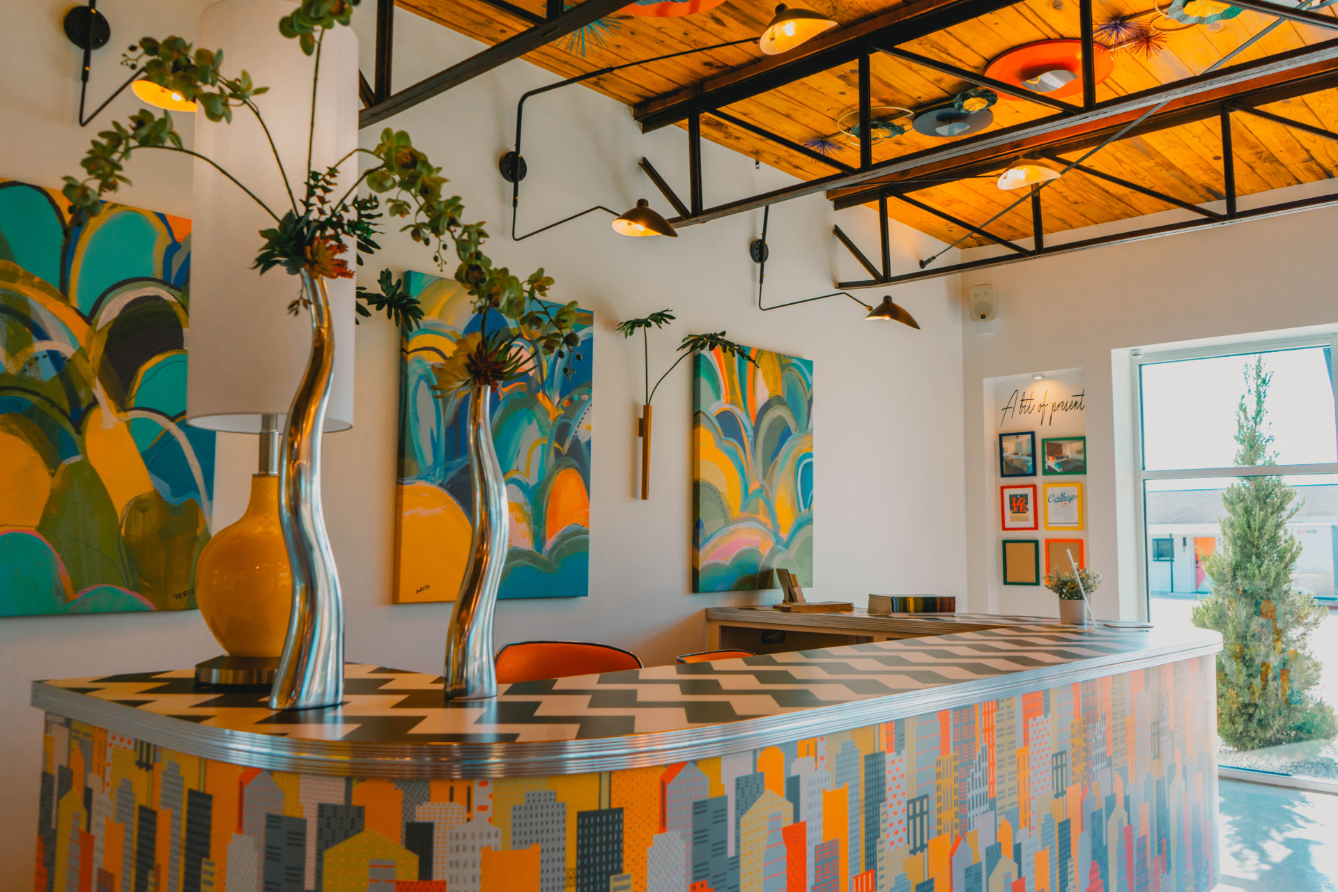 The Riviera front desk with patterned counter and bright original paintings